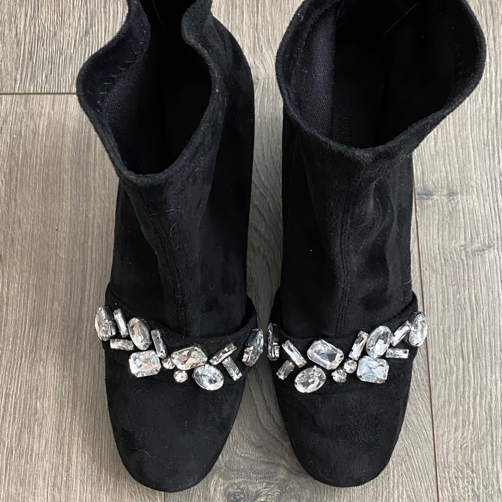 Black heeled booties with jewels across the front